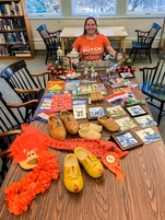 Interior Library, Monique Pritchard Sitting With Her Collection Of Dutch Items Displayed On A Large Tabletop