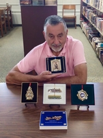 David Kozemchak Sitting At A Table With 5 White House Historical Association Christmas Ornaments