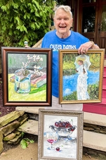 Bruce Miles Holding 3 Of His Paintings