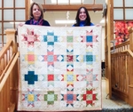 2024 Quilt &#8220;Mending Stars&#8221; Held By (Left To Right) Karen Shuster And Liz Caputo