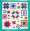 Quilt With Bright Primary Colored Stars On A White Background With Green Edging, "All Stars" By Leslie Horoshko